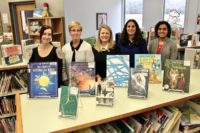 Staff and adopter with adopted books