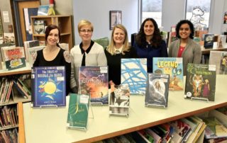 Staff and adopter with adopted books
