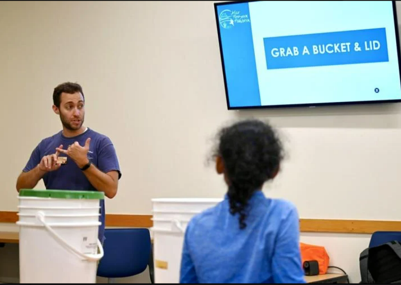 Cody Hace, left, of the Alice Ferguson Foundation leads a community workshop on Saturday at the Charles County Library Potomac Branch covering the importance of composting.