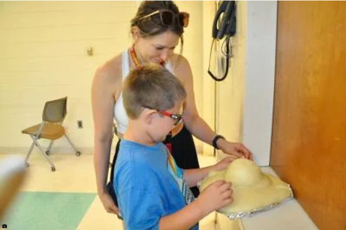 Seven-year-old Hunter Stewart, front, and his mother Jennifer, both of Waldorf, touch some Gloop Glop, otherwise known as polyurethane foam.