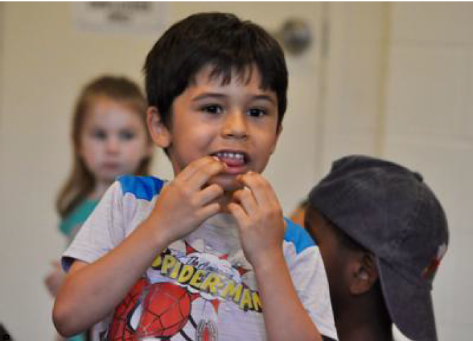 Jehiel Alequin, 5, of Waldorf reacts after seeing an experiment during a Mad Science presentation July 3 at the Charles County Public Library.