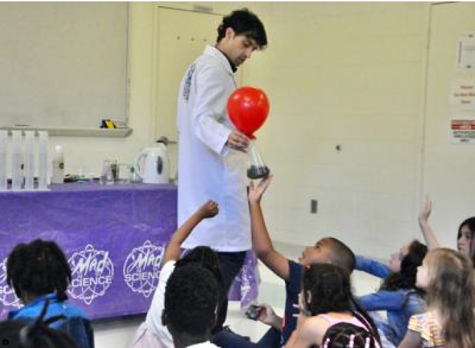 Mad Science Guy (also known as Tony Smith of Washington, D.C.) allows Christian Twyman, 7, of White Plains to feel the heat of a jar.