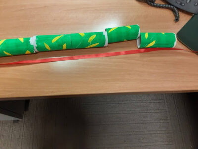 Lay the toilet paper tubes end to end and cut a ribbon a little longer than the tubes as the extra will serve as the snake’s tongue.