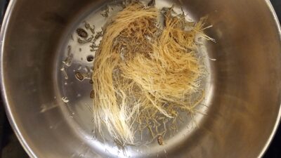 Step Three: The bag of Vermicelli noodles can be divided in half. You will use half of the vermicelli now, and you can save the other half for later. Separate and break the vermicelli into 1 1/2-inch pieces. Add the broken Vermicelli to your heating oil. Continue stirring until the mixture is light brown, but not burnt.