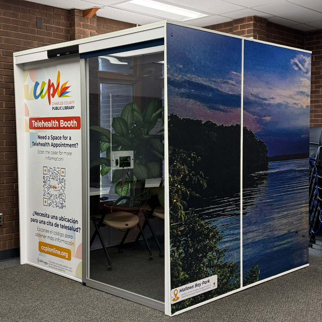 Telehealth booth at P.D. Brown Memorial Branch with nature-themed exterior panels and glass door entrance.